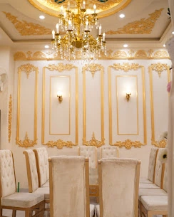 White and gold dining hall with chandelier and wall sconces