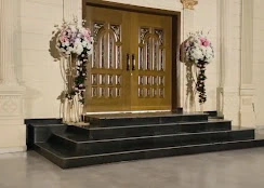 Entrance steps flanked by floral stands