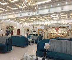 Main hall with teal lounge seating and chandeliers