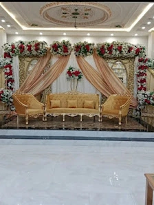 Blush drapes and red rose stage with gold sofa