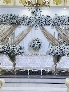 All-white floral stage with silver furniture